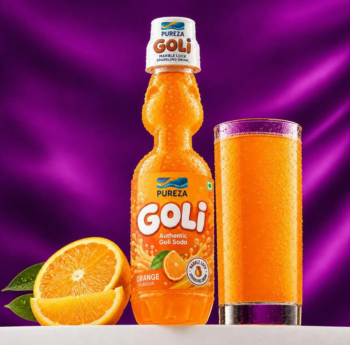A marble-lock bottle of PUREZA Goli orange soda beside a filled glass and fresh oranges