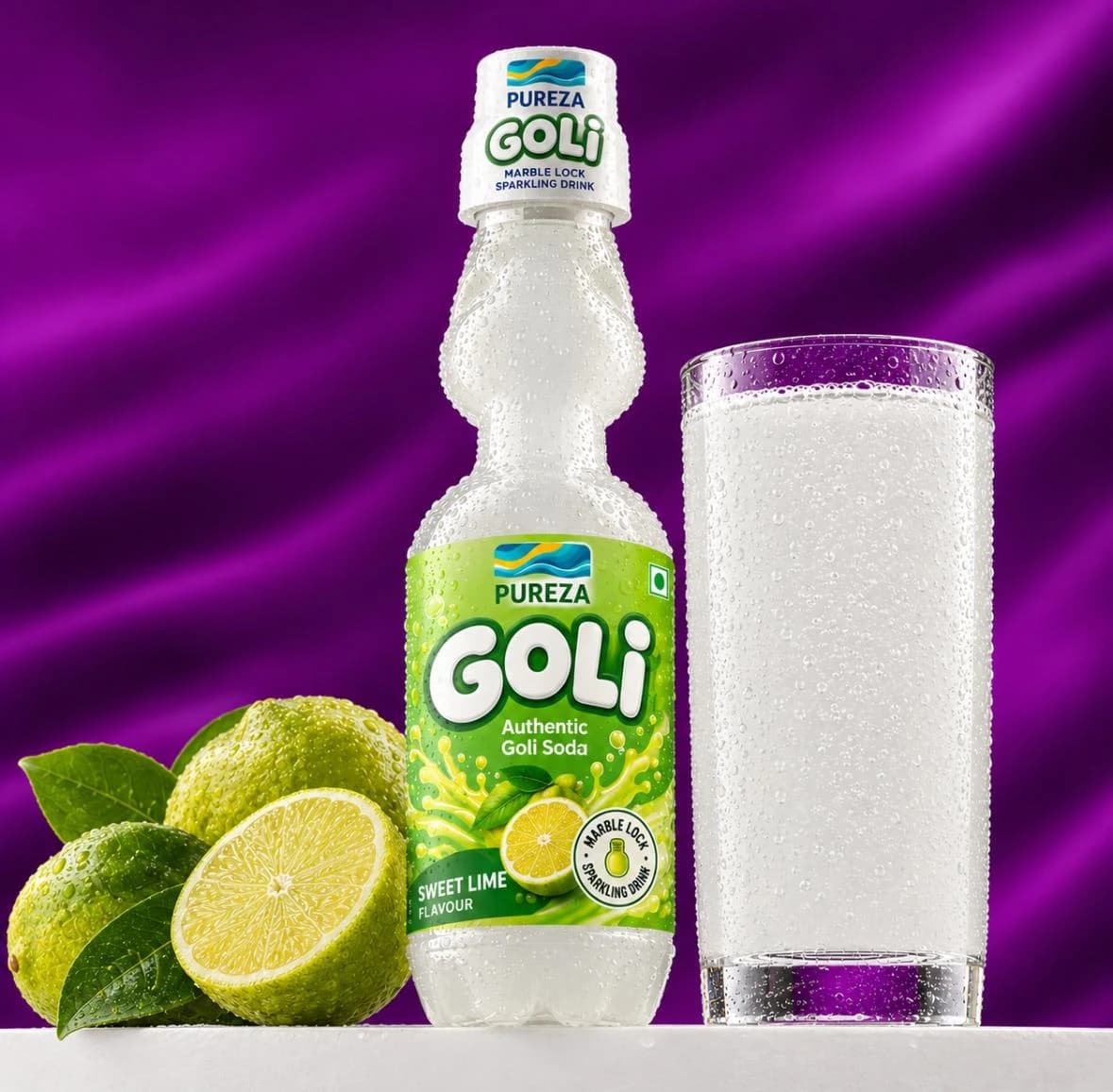A marble-lock bottle of PUREZA Goli sweet lime soda beside a filled glass and fresh limes